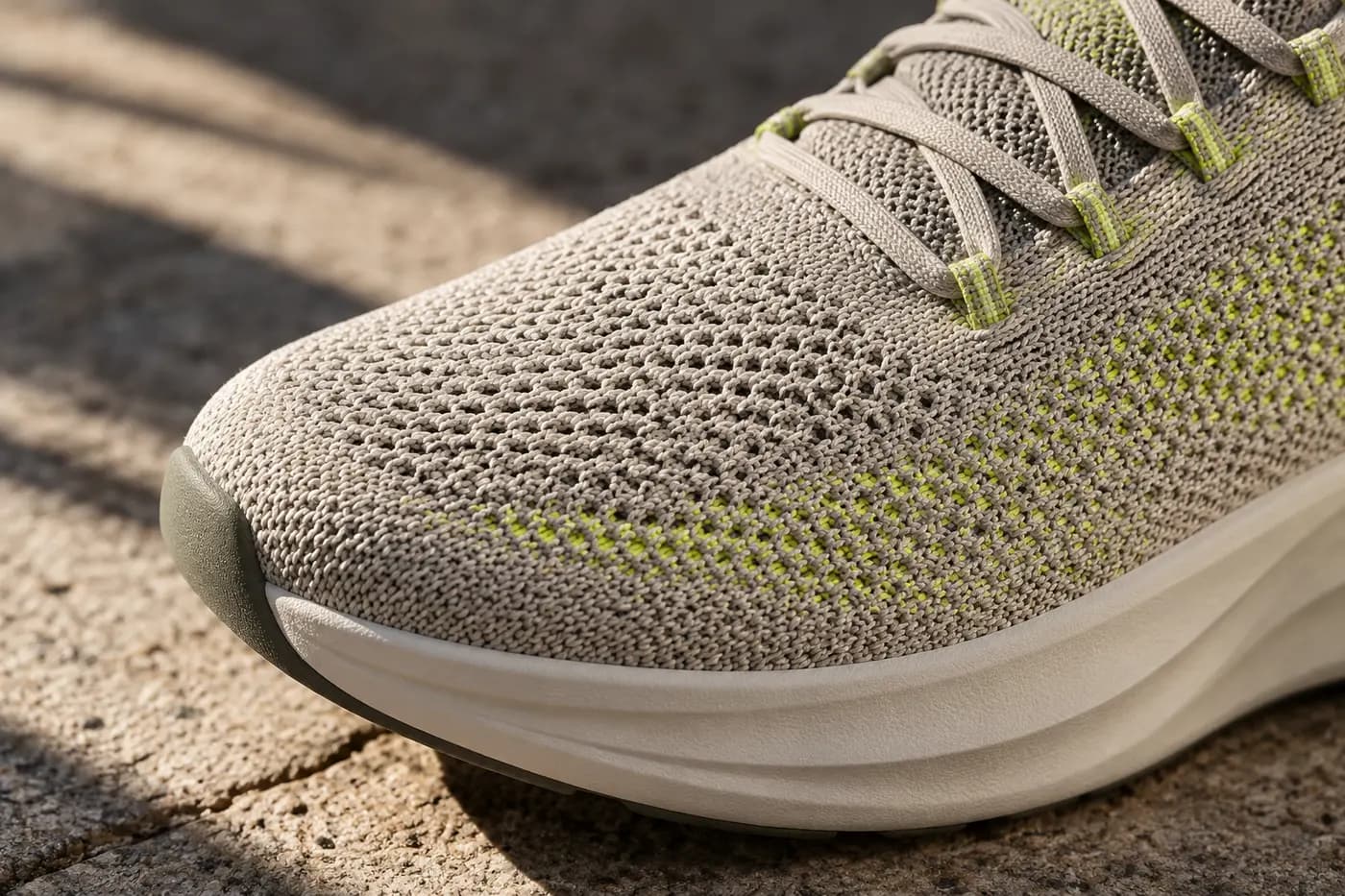 Macro of knitted mesh sneaker upper with lime thread